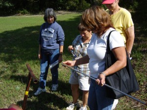 Students in a soils class looking at a soil sample.