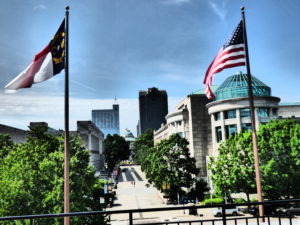 North Carolina and American Flags over Capitol Building