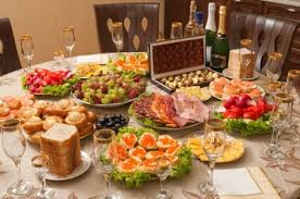 A table set with traditional American holiday foods-ham, deviled eggs, vegetable dishes
