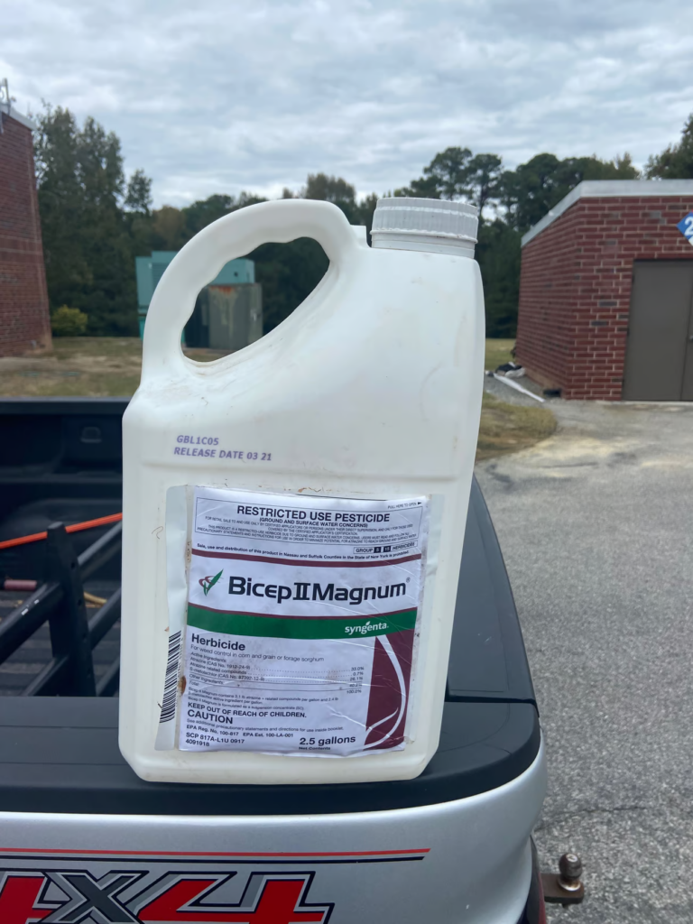 White pesticide bottle on truck tailgate.